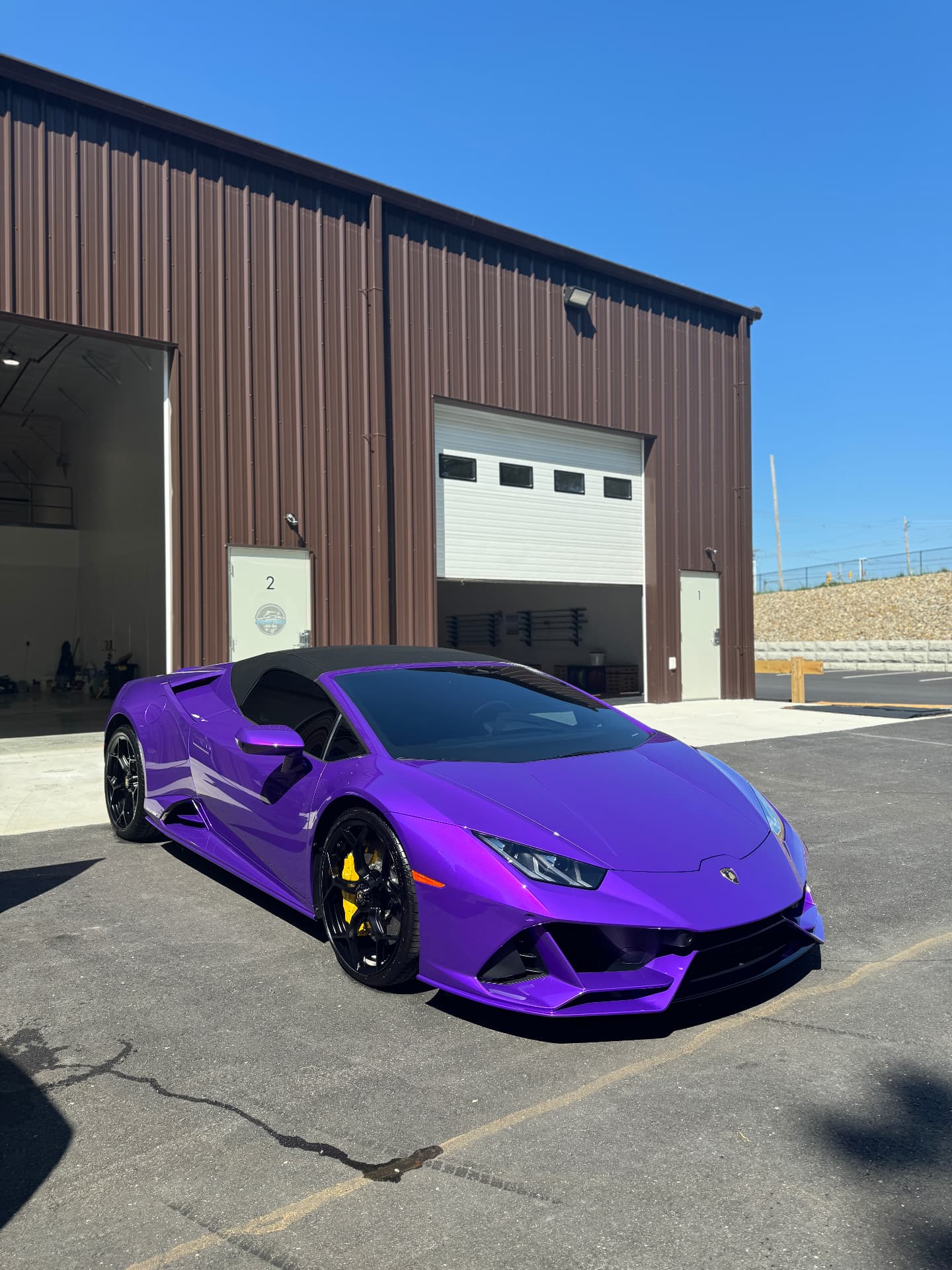 Purple Lamborghini Huracan ceramic coating finish at Secret Touch Auto Spa storefront Shrewsbury MA