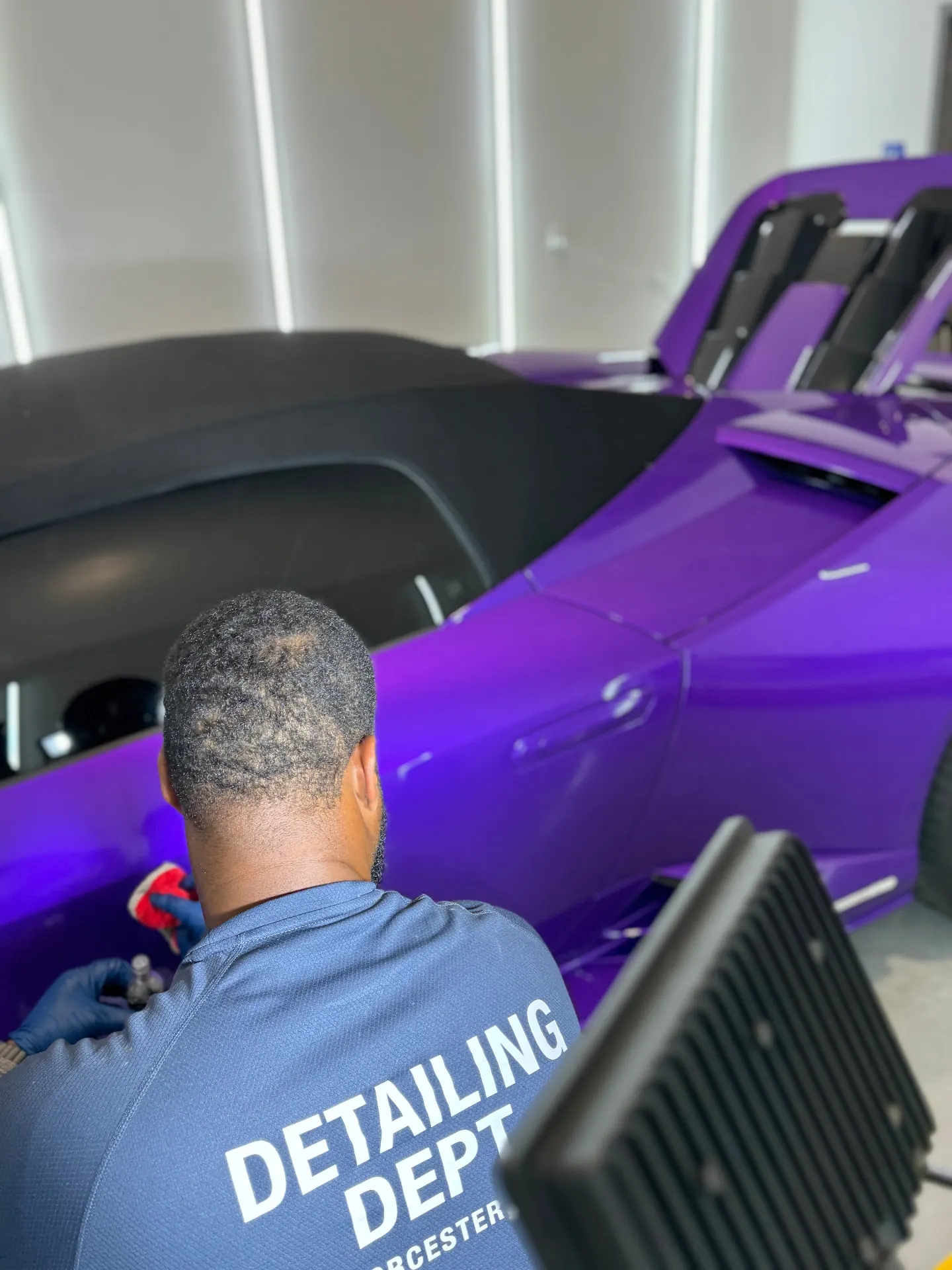 Technician applying ceramic coating to purple Lamborghini Huracan at Secret Touch Auto Spa Shrewsbury MA