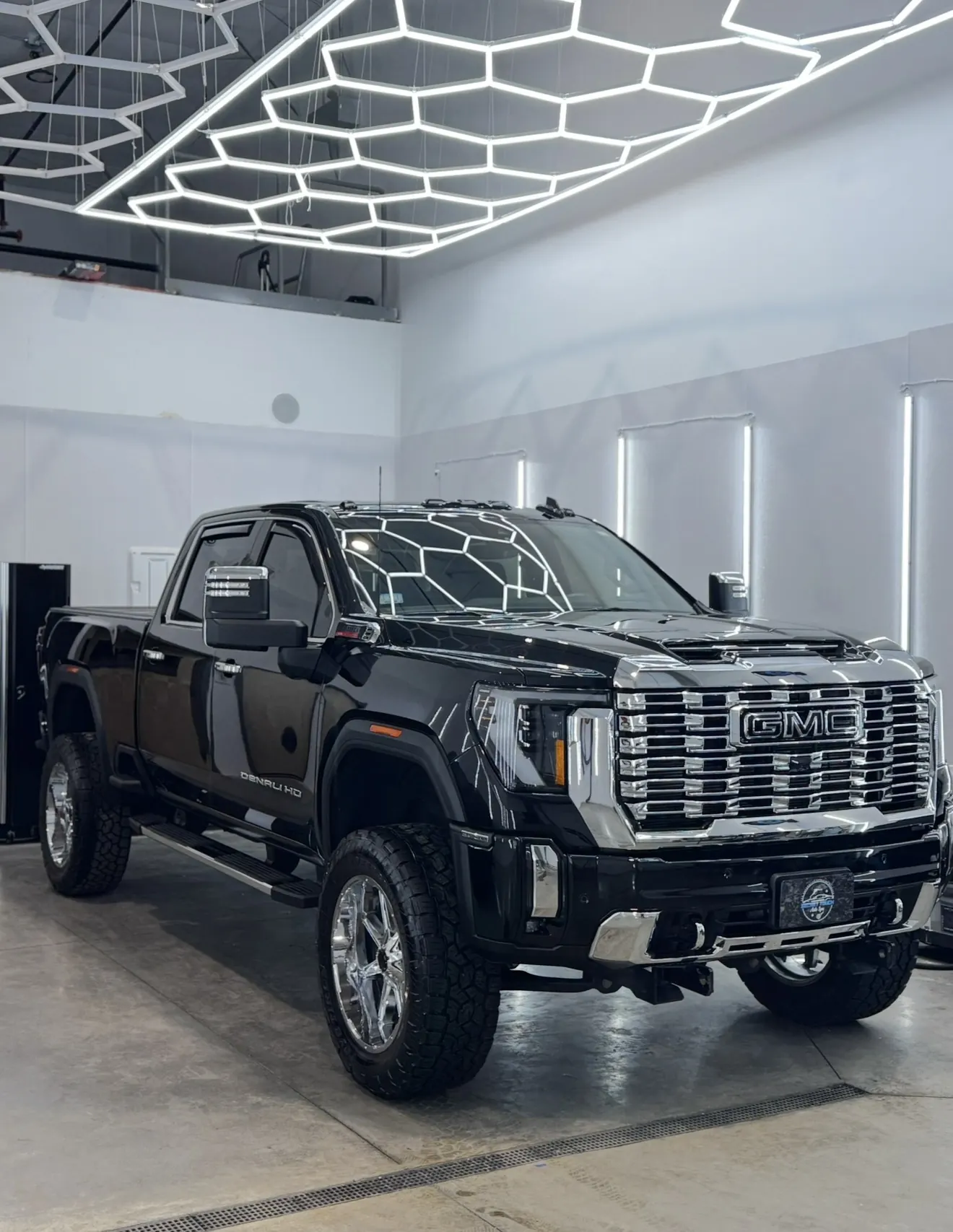 Black GMC Sierra Denali HD after 2-step paint correction and ceramic coating outside in natural light at Secret Touch Auto Spa Shrewsbury MA
