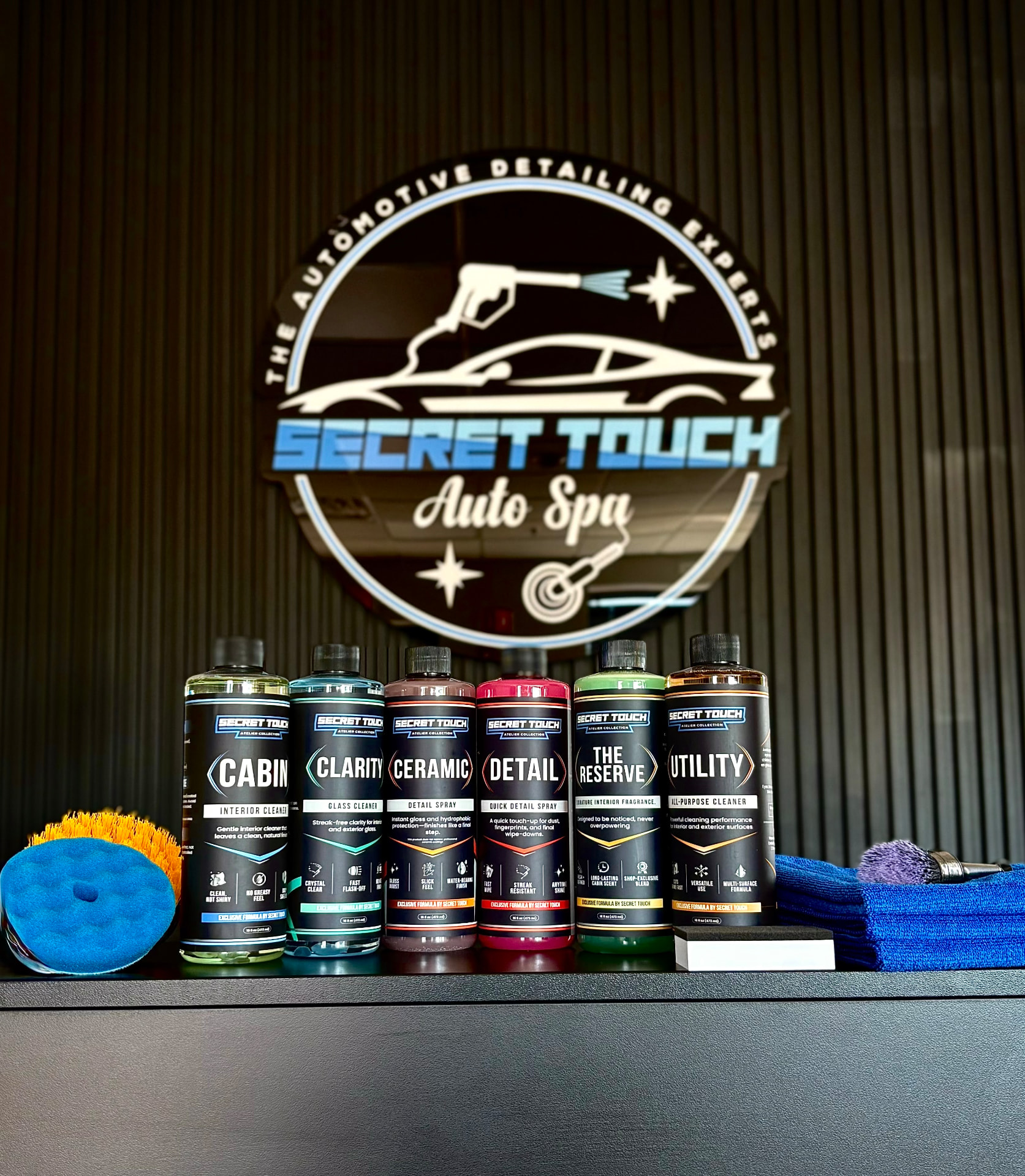 Complete Secret Touch Atelier Collection displayed at Secret Touch Auto Spa in Shrewsbury MA - six professional car care products
