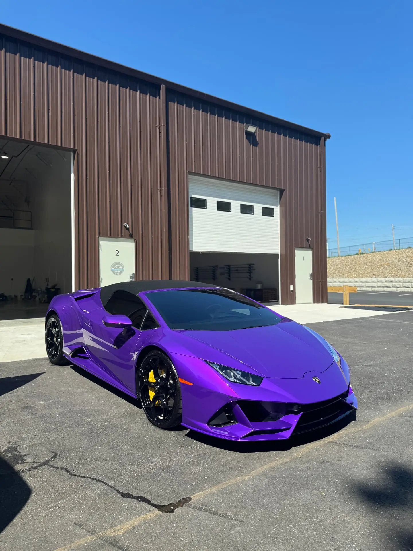 Purple Lamborghini Huracan ceramic coating finish at Secret Touch Auto Spa storefront Shrewsbury MA