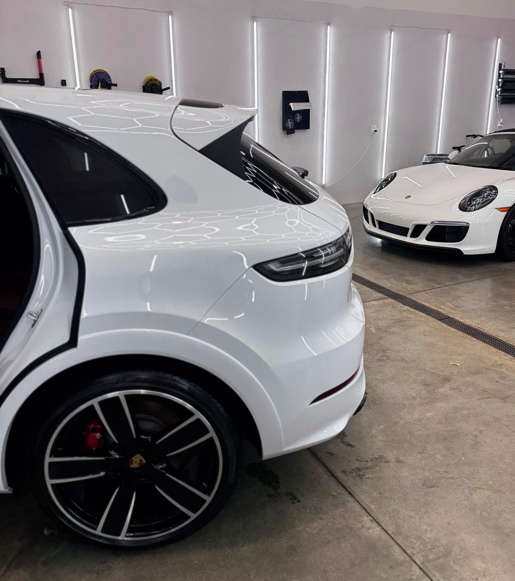 White Porsche Cayenne GTS and Porsche 911 Carrera GTS after ceramic coating at Secret Touch Auto Spa in Shrewsbury MA