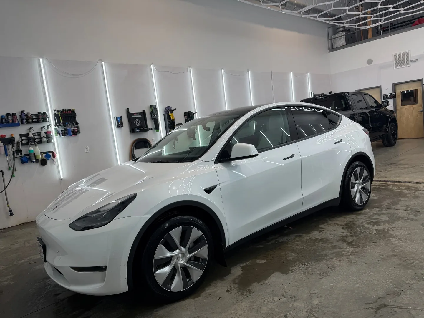 White Tesla Model Y after detailing and protection at Secret Touch Auto Spa Shrewsbury MA