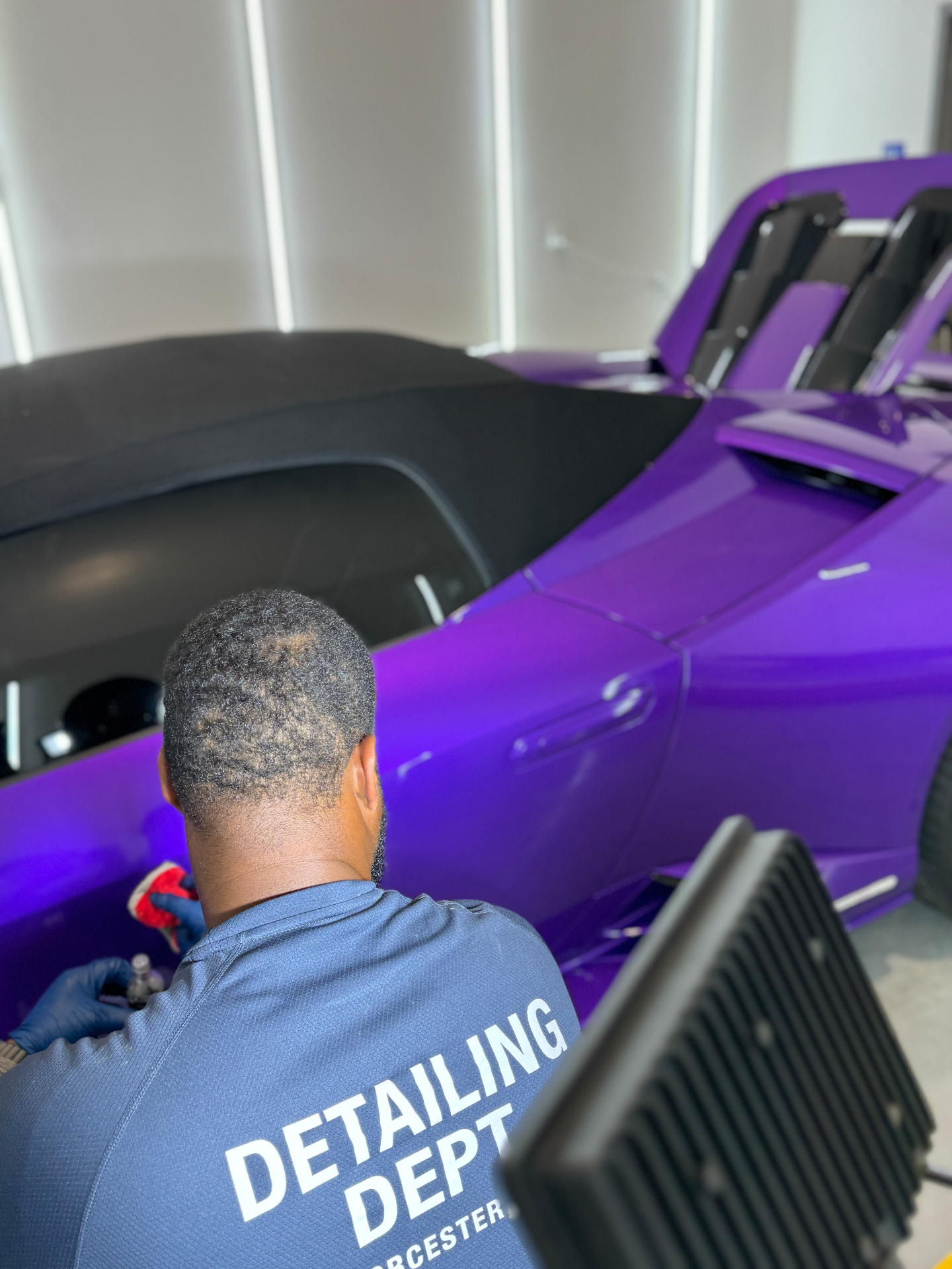 Technician applying ceramic coating to purple Lamborghini Huracan at Secret Touch Auto Spa Shrewsbury MA