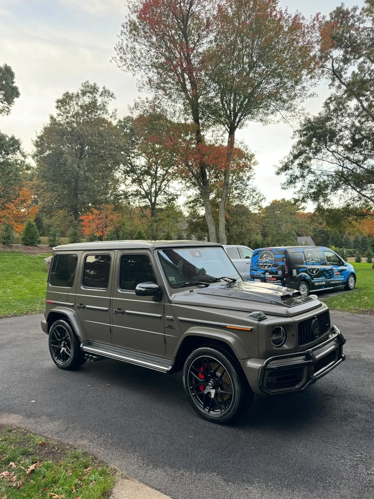 Matte Mercedes G63 mobile detailing with service vans in background