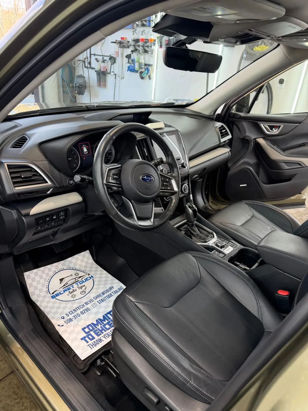 Subaru interior after professional detailing with clean carpet and branded floor mat Shrewsbury MA