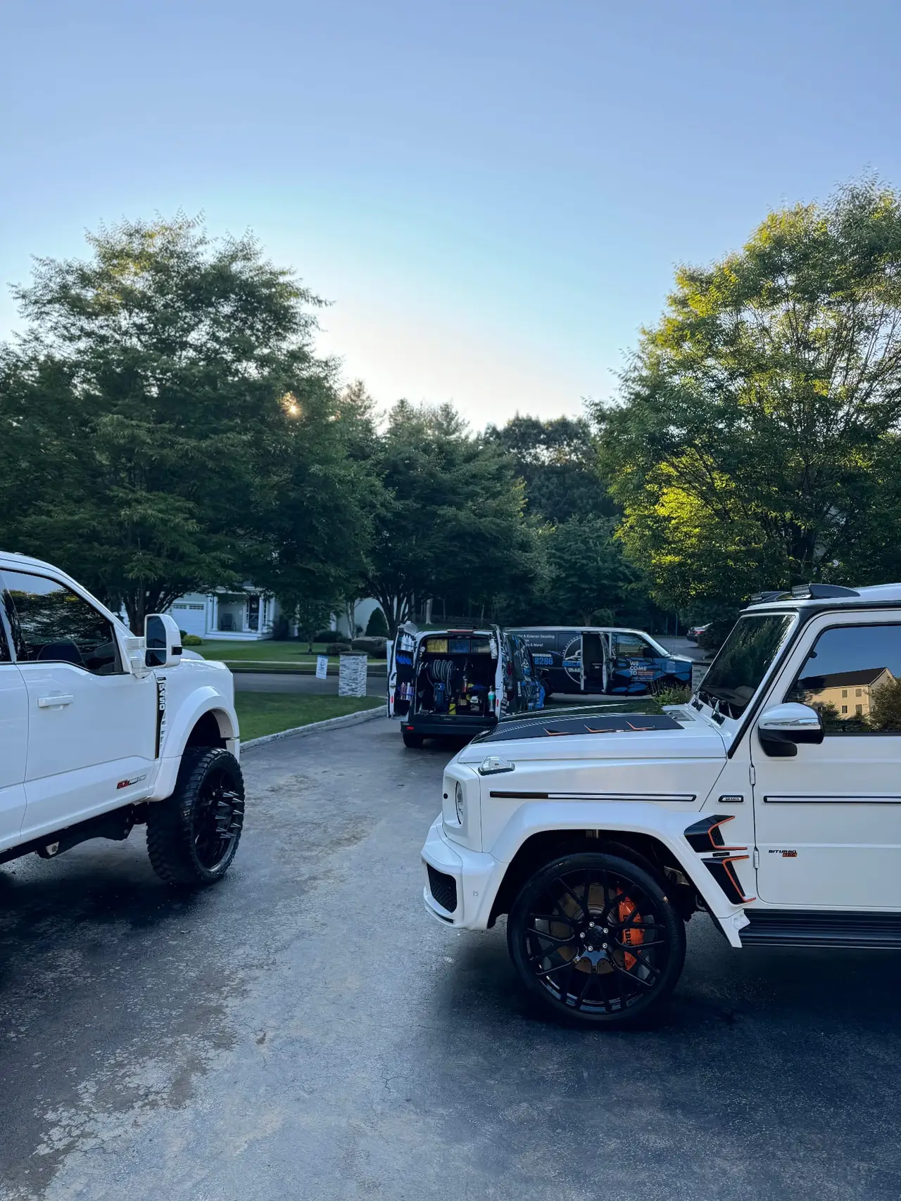 White Mercedes G63 Brabus and Ford F250 with mobile detailing service vans